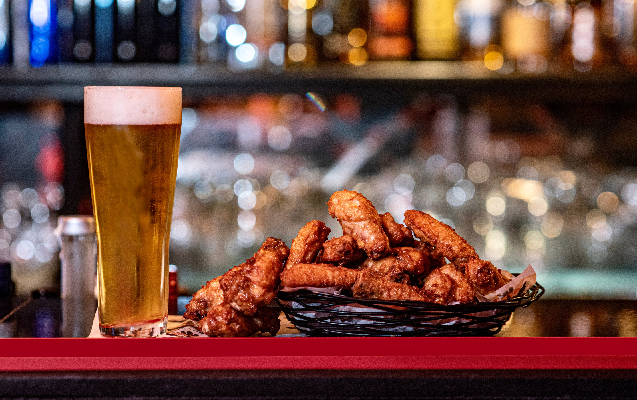 A plate of a beer and chicken wings